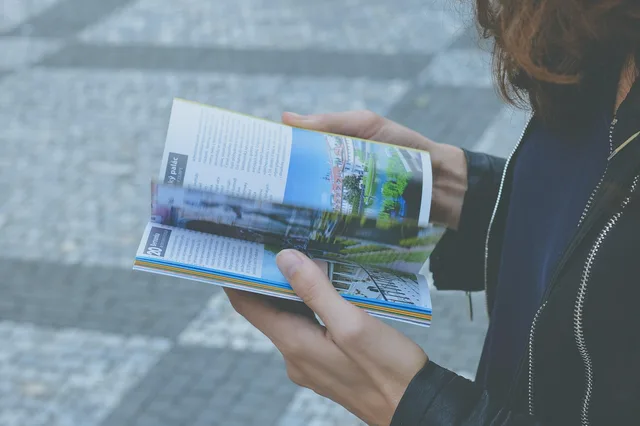 book, hands, pages, person, reading, blue book, blue books, blue reading. How to read an annual trend report in about twenty minutes