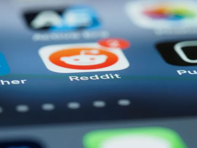Detailed close-up of a smartphone screen showing the Reddit app with a notification badge. What to know about feed algorithms platforms, and why it matters