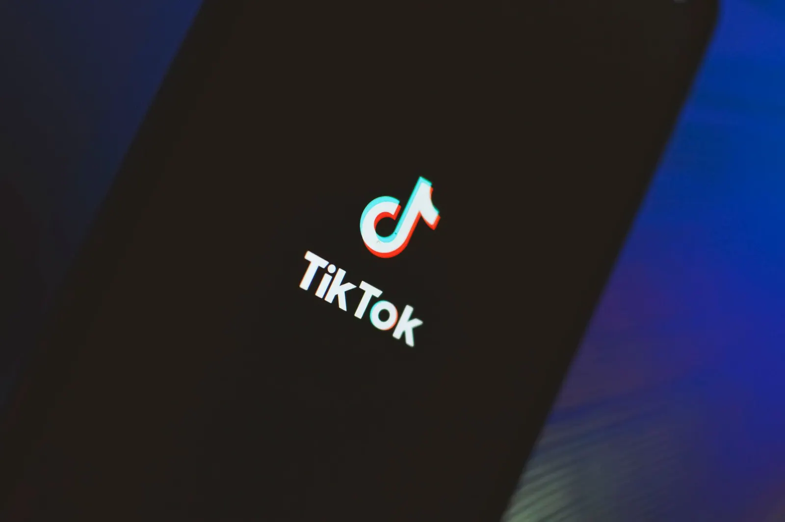 A close-up view of the TikTok app logo illuminated on a smartphone screen. The risks of going viral arrive in a predictable order